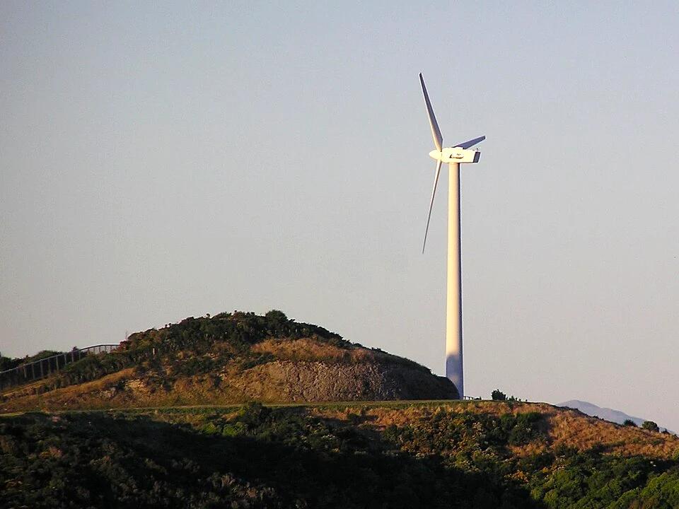 A wind turbine on a Wellington hilltop at dusk